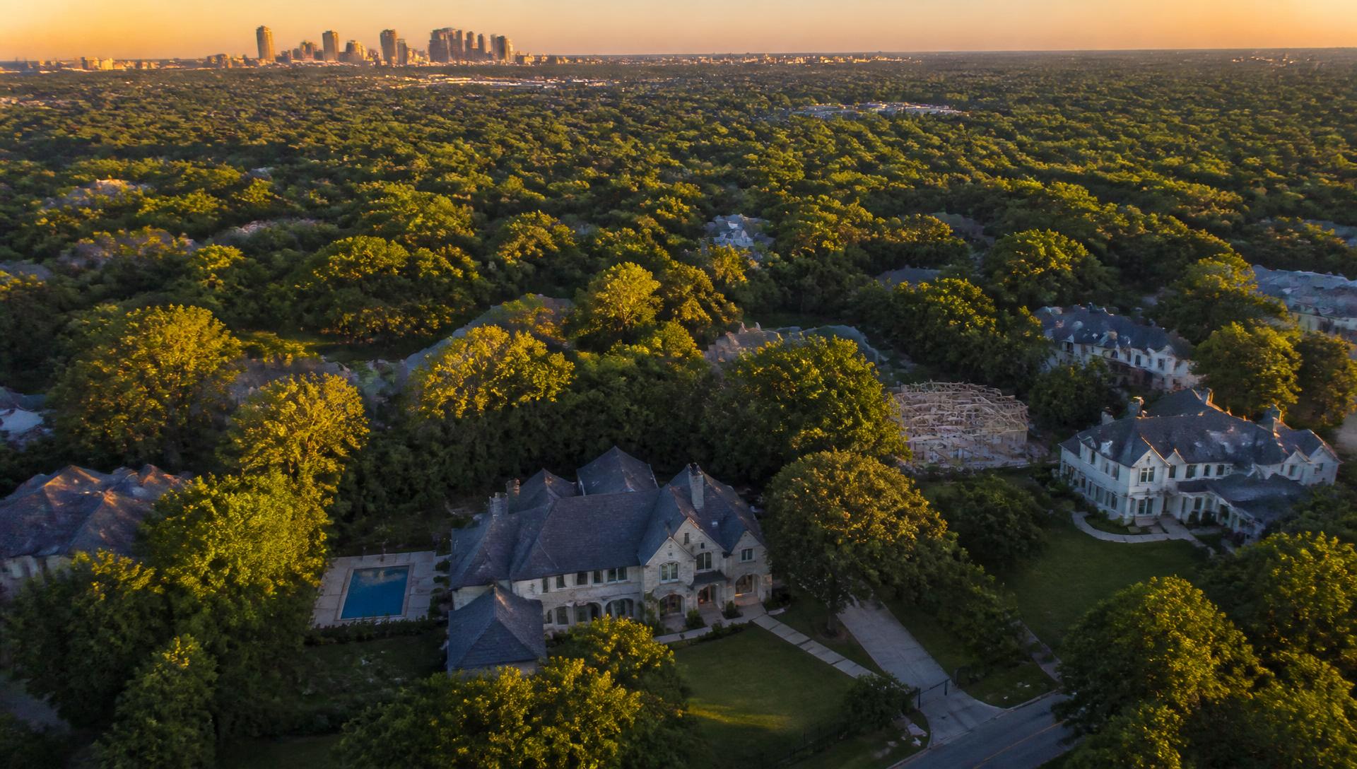 Aerial view of a Dallas neighborhood with mature tree canopy